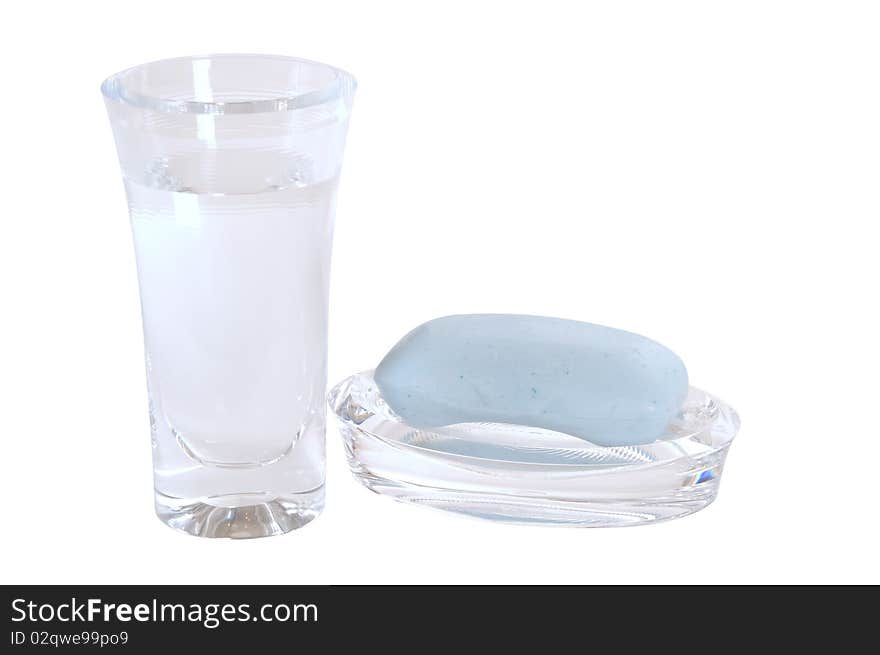 Glass full of water and soap bar isolated over white. Glass full of water and soap bar isolated over white.