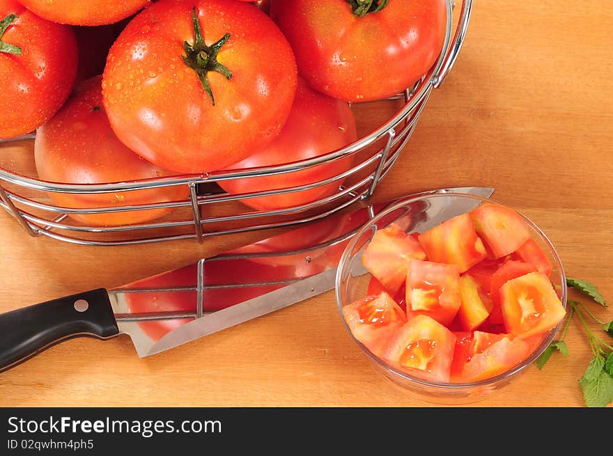 Chopped tomato and kitchen knife on cutting board. Chopped tomato and kitchen knife on cutting board.