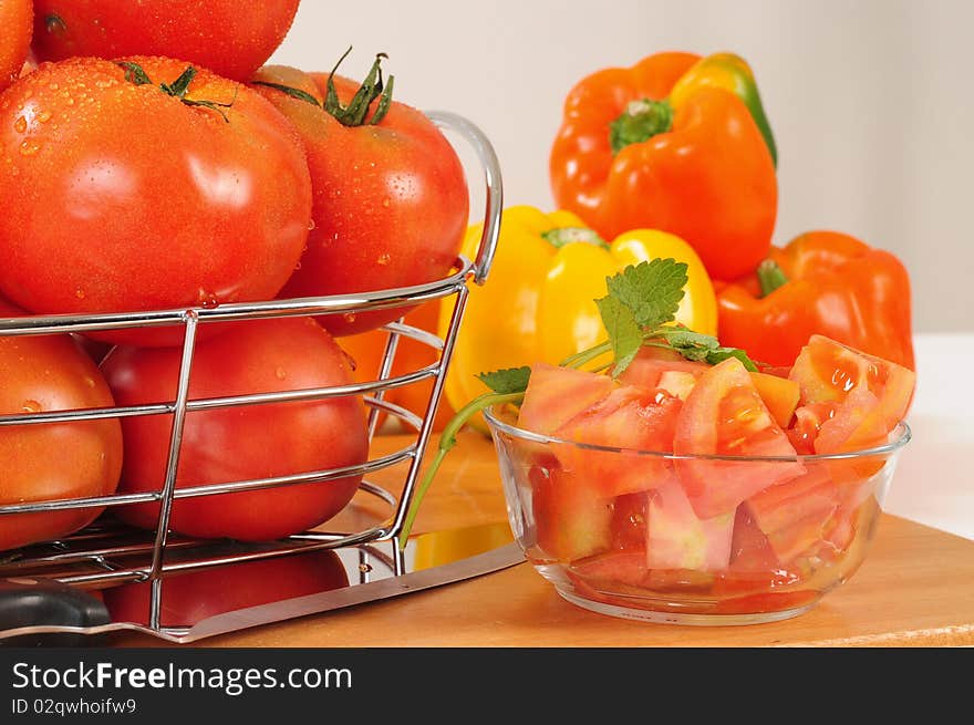 Chopped tomato and pepper bell on cutting board. Chopped tomato and pepper bell on cutting board.