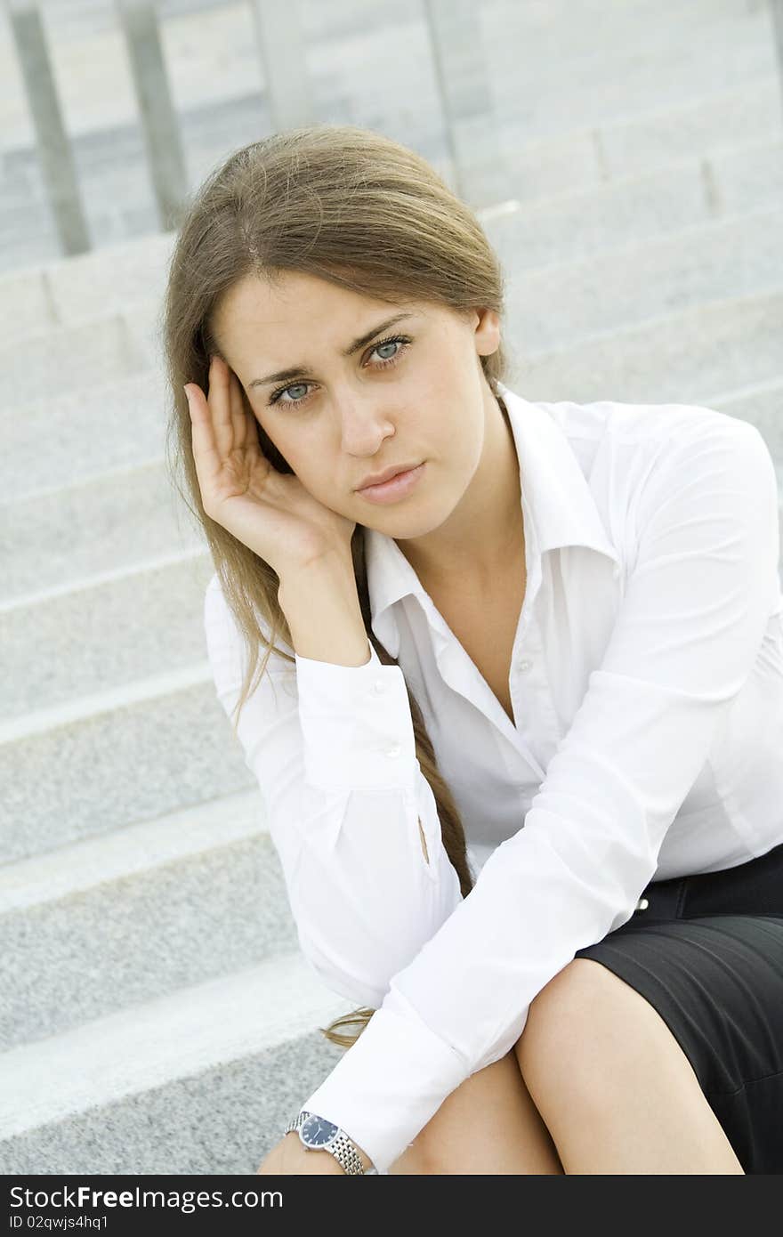 Young business woman tormented by headaches cares about the work. Young business woman tormented by headaches cares about the work