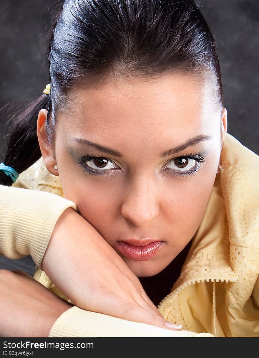 Pretty brunette in yellow posing , studio shot