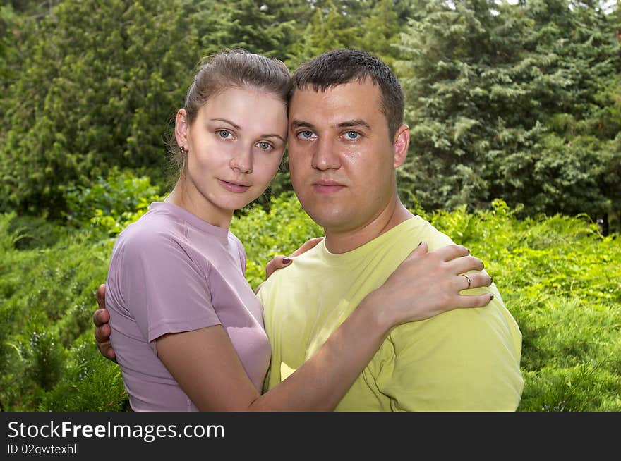 Young couple in the park over defocused background