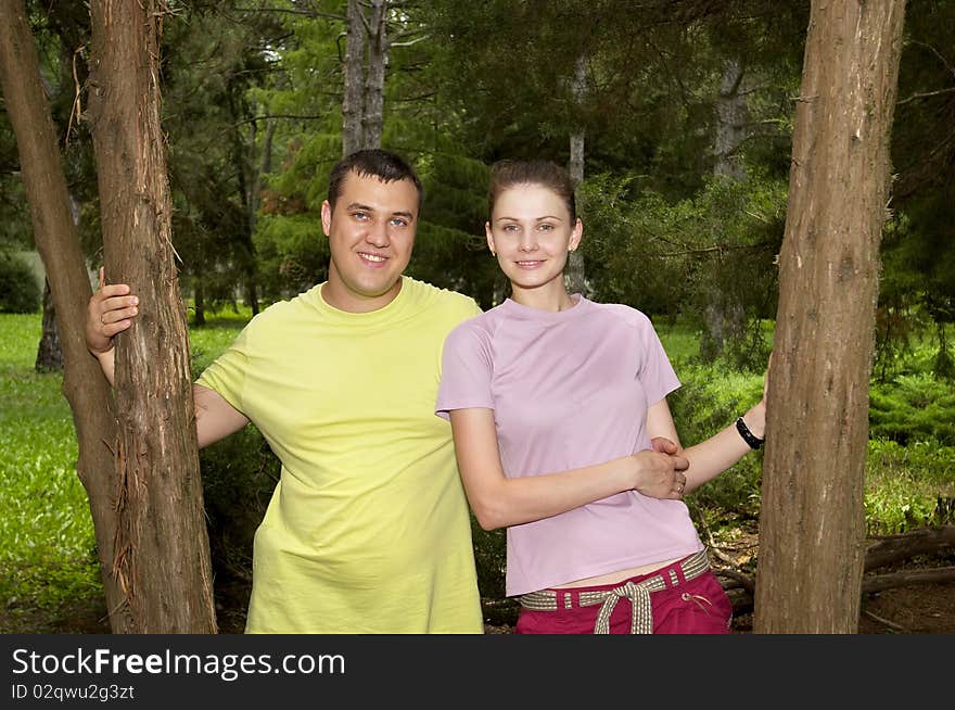 Young couple in the park over defocused background