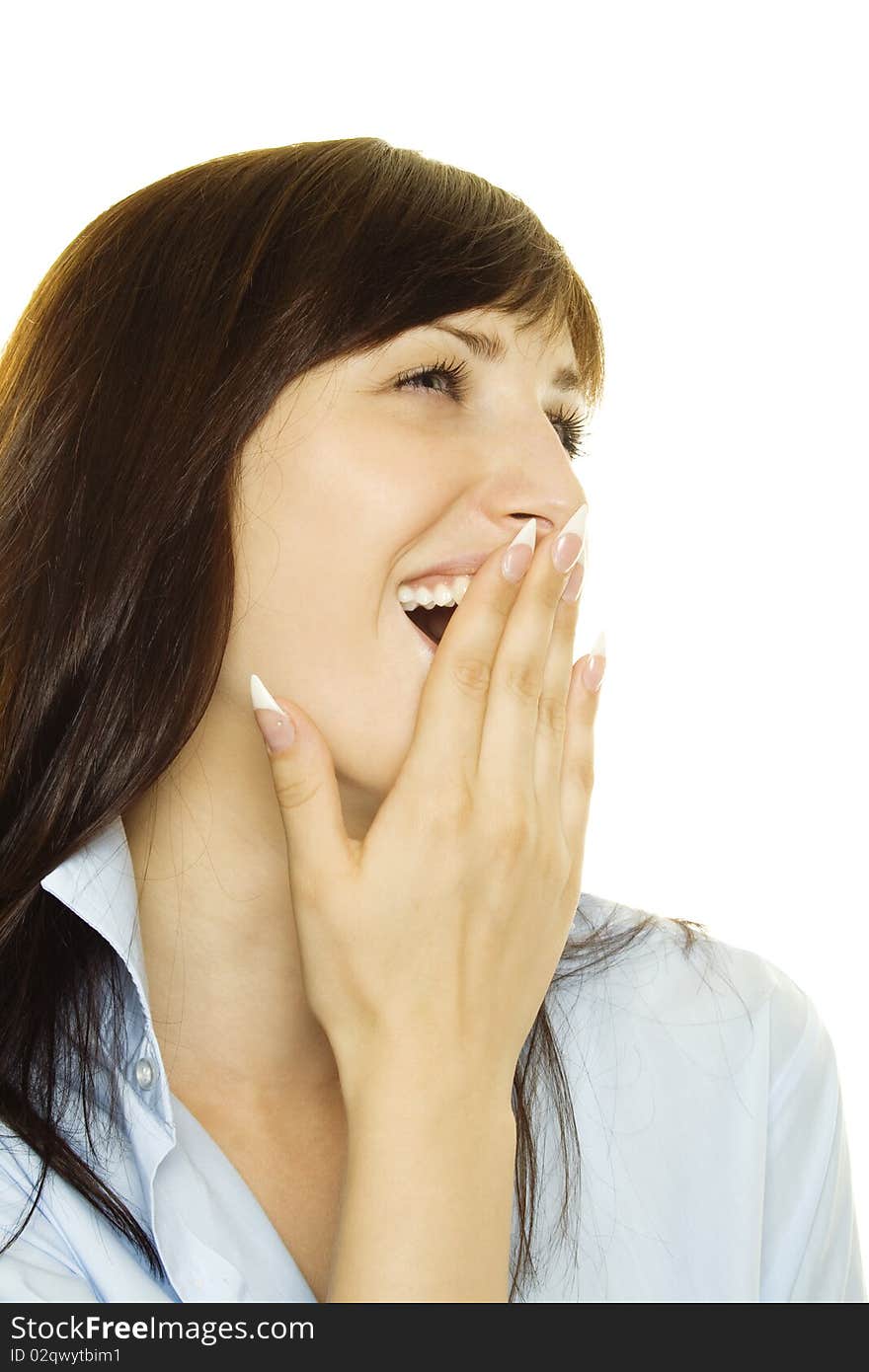 Young woman in a blue men's shirt, laughs and covers her mouth with his hand. Young woman in a blue men's shirt, laughs and covers her mouth with his hand