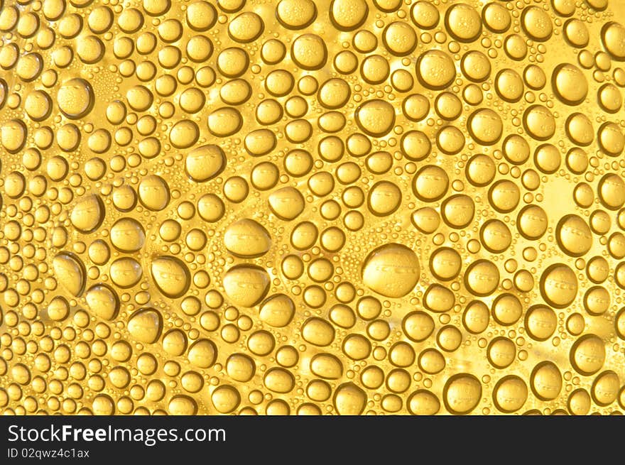 Water droplet in yellow color background texture