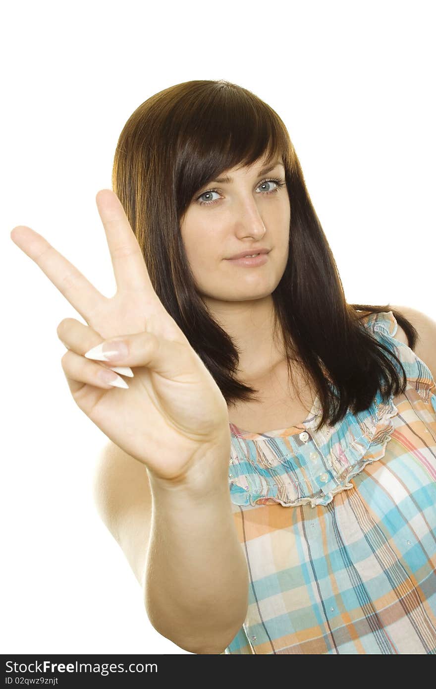 Young smiling woman making victory gesture. Isolated on white background. Young smiling woman making victory gesture. Isolated on white background