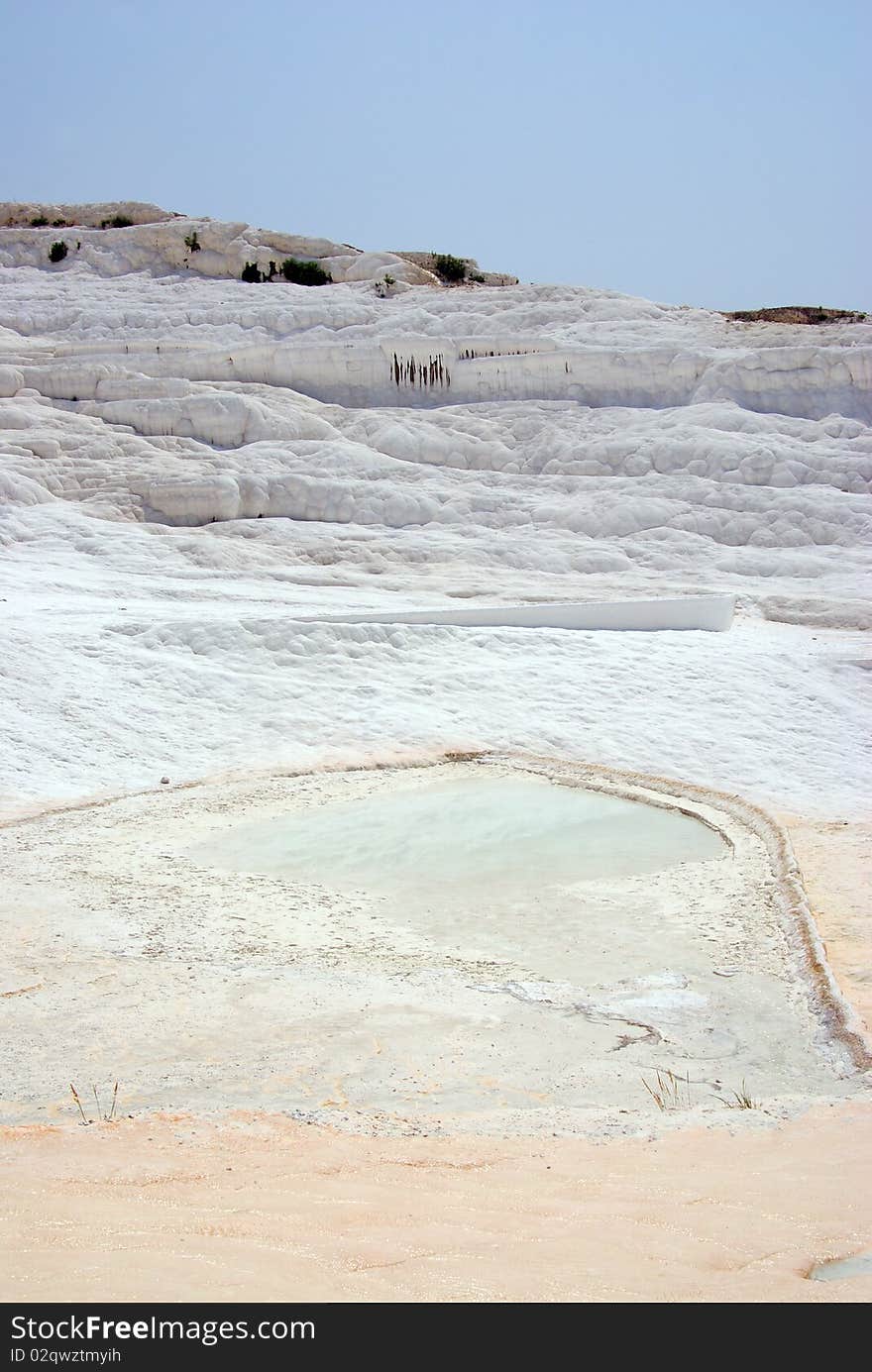 Pamukkale: panorama with calcium relief and warm water lake