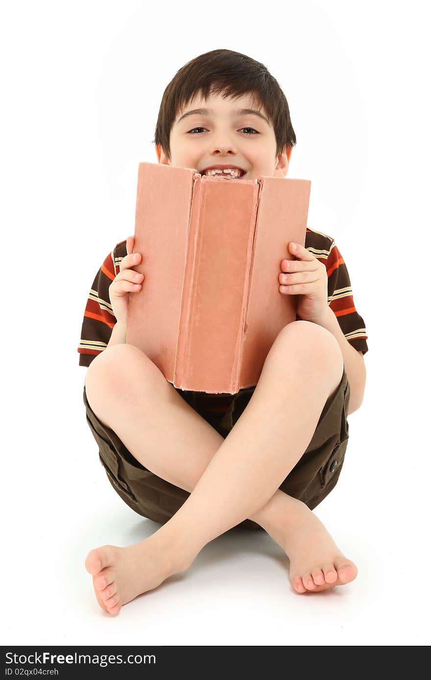 Casual happy seven year old french american boy with large book over white background. Casual happy seven year old french american boy with large book over white background.