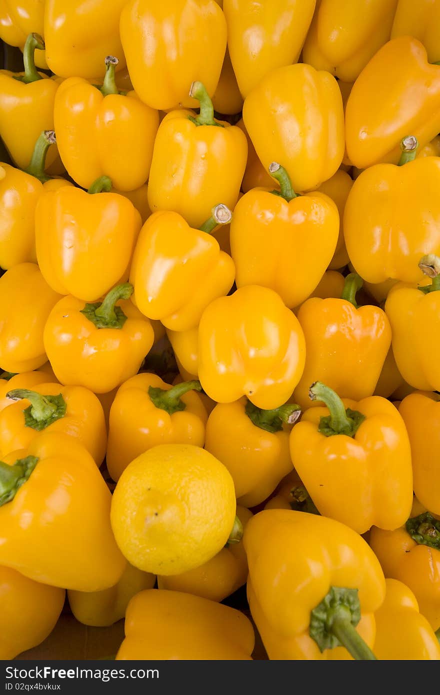 Fresh Yellow Peppers Arranged At Market