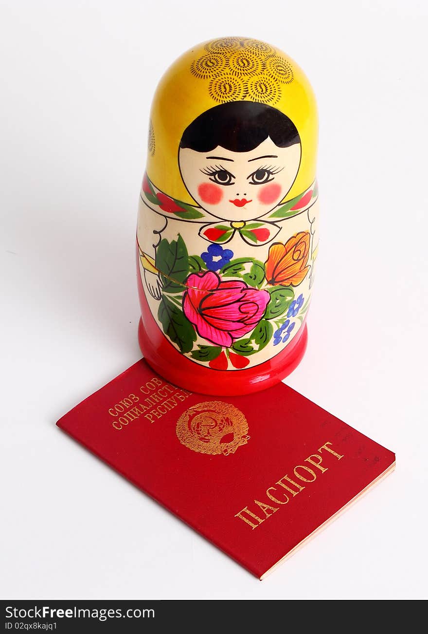 Russian Nesting Doll standing on USSR Passport