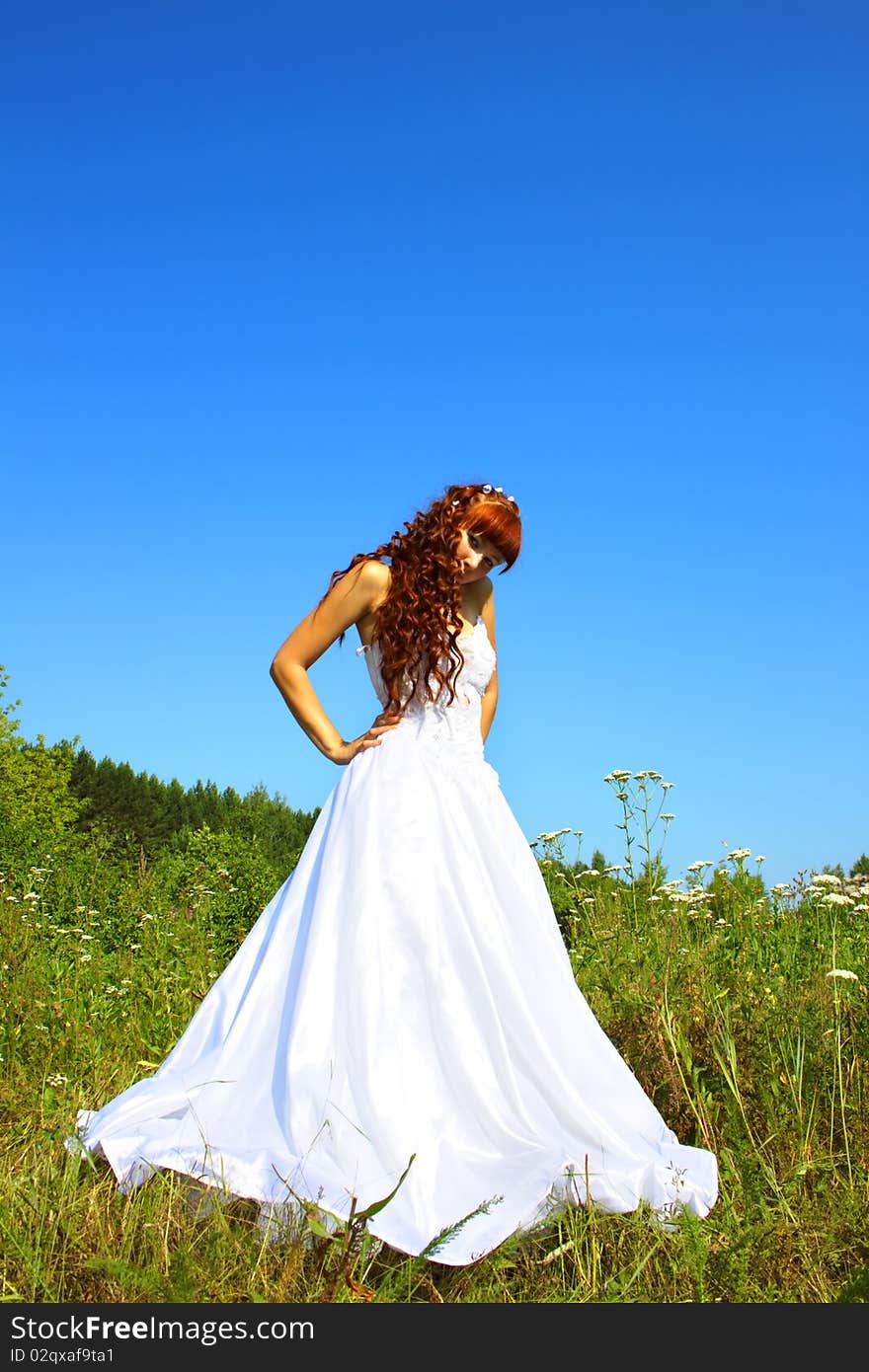 Bride in nature against the sky