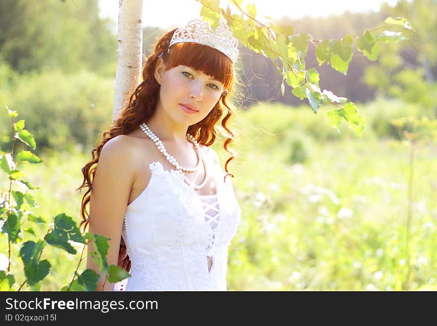 Beautiful girl near to a birch