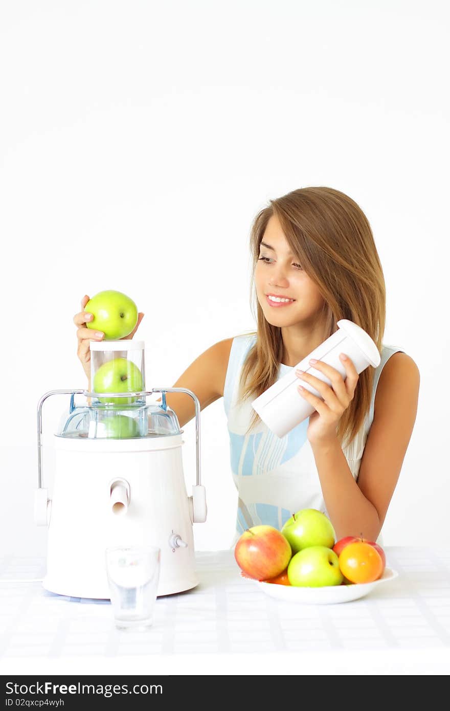 girl squeezes the juice from the juicer