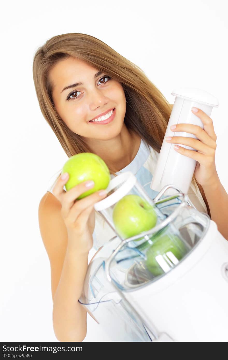 Happy girl about juicer on a light background