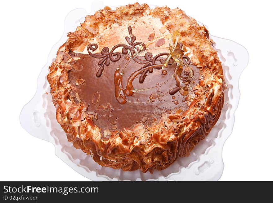 Torte on a white plastic plate. Isolated on a white background.