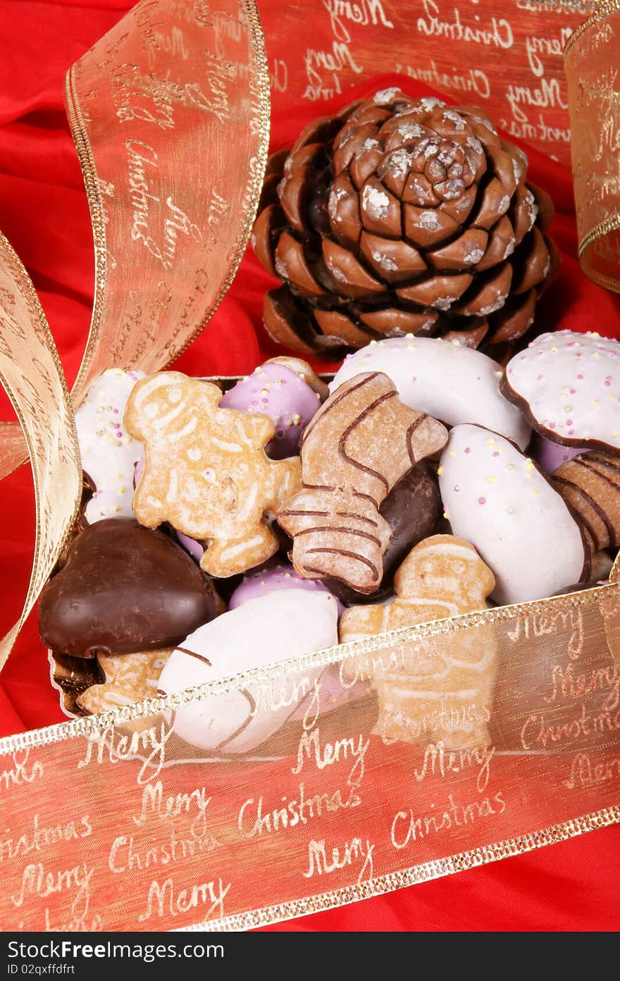 Assorted Christmas gingerbread cookies and Christmas decorations over a red background