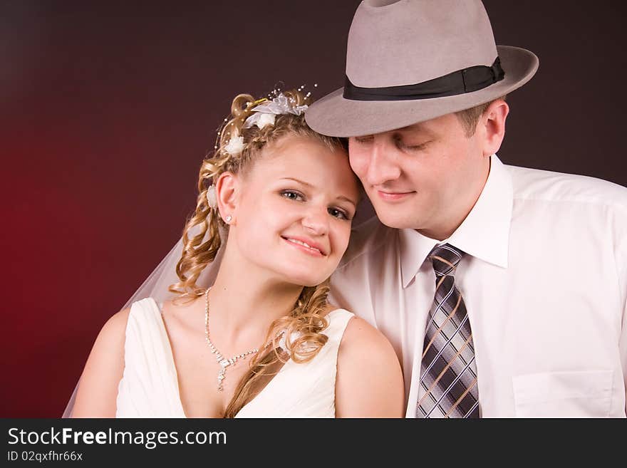 Photography of happy newly-wed is in a studio