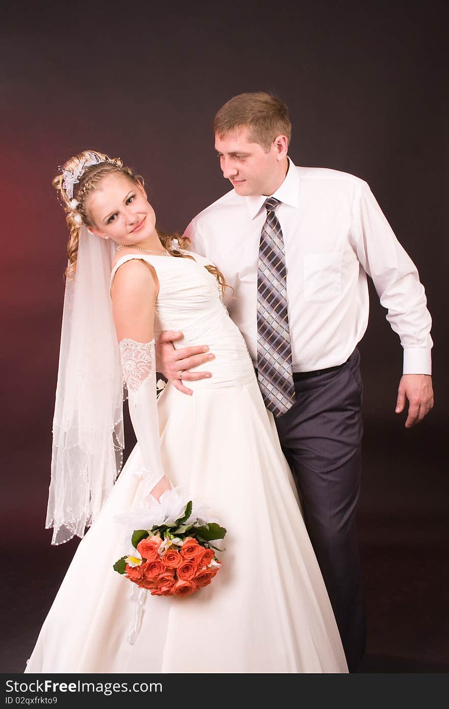 Photography of happy newly-wed is in a studio