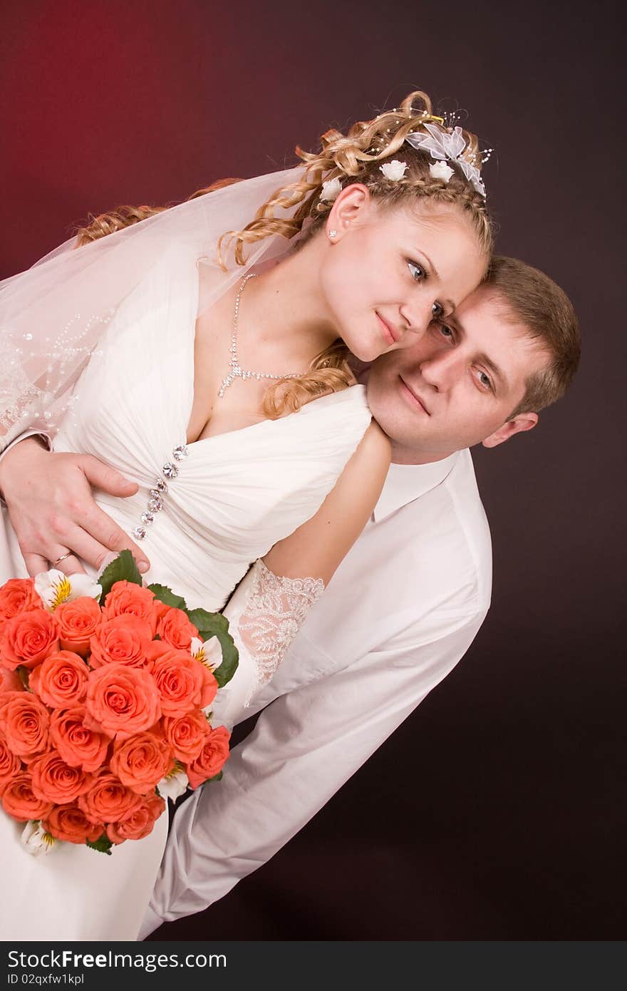 Photography of happy newly-wed is in a studio