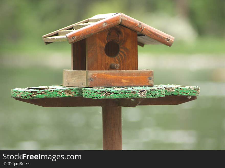 Wooden bird house with blurred background. Wooden bird house with blurred background.