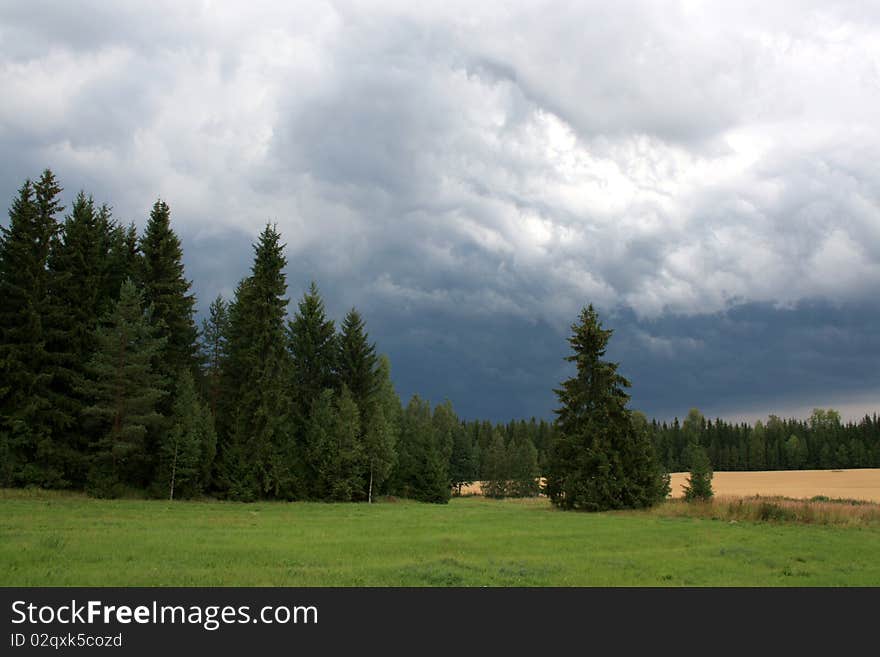 Storm clouds approaching countryside