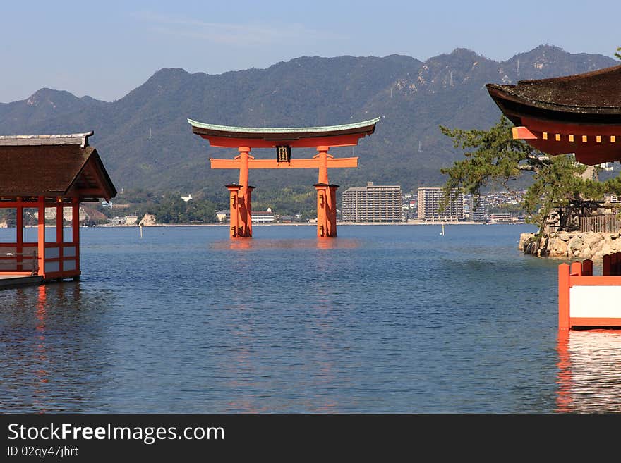 Beautiful Torii in Miyajima at high tide with mountains in background. Beautiful Torii in Miyajima at high tide with mountains in background