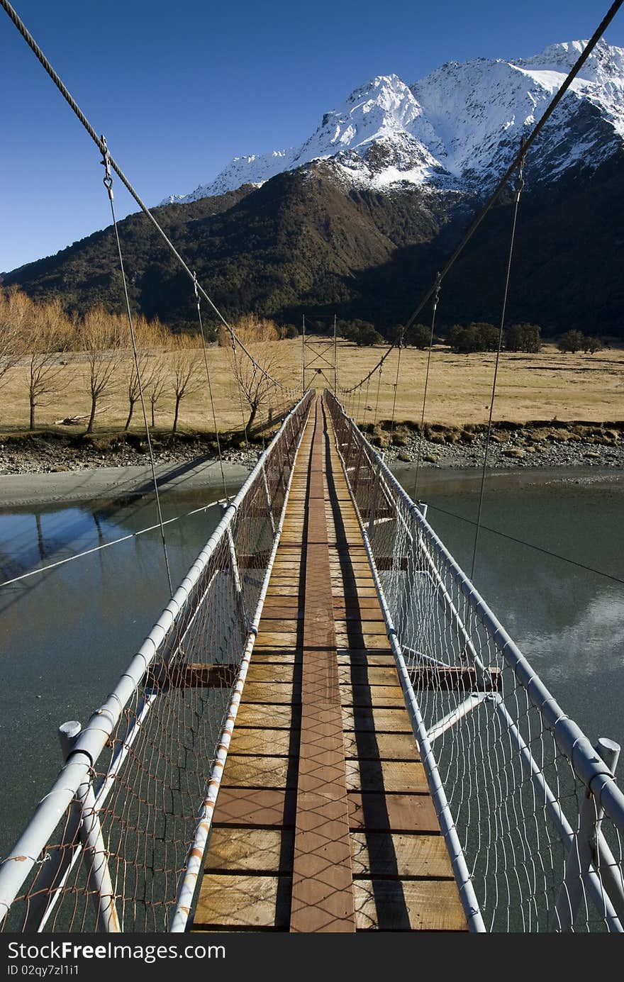 Swing Bridge crossing the Matukituki River. Mount Aspiring National Park. South Island, New Zealand. Swing Bridge crossing the Matukituki River. Mount Aspiring National Park. South Island, New Zealand.