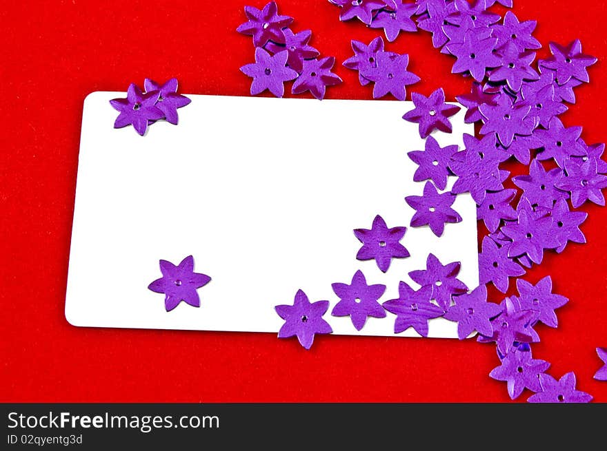 White card and violet stars on red background