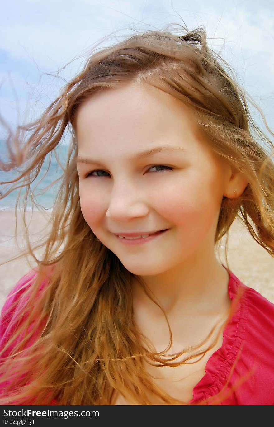 Happy girl by the sea in summer