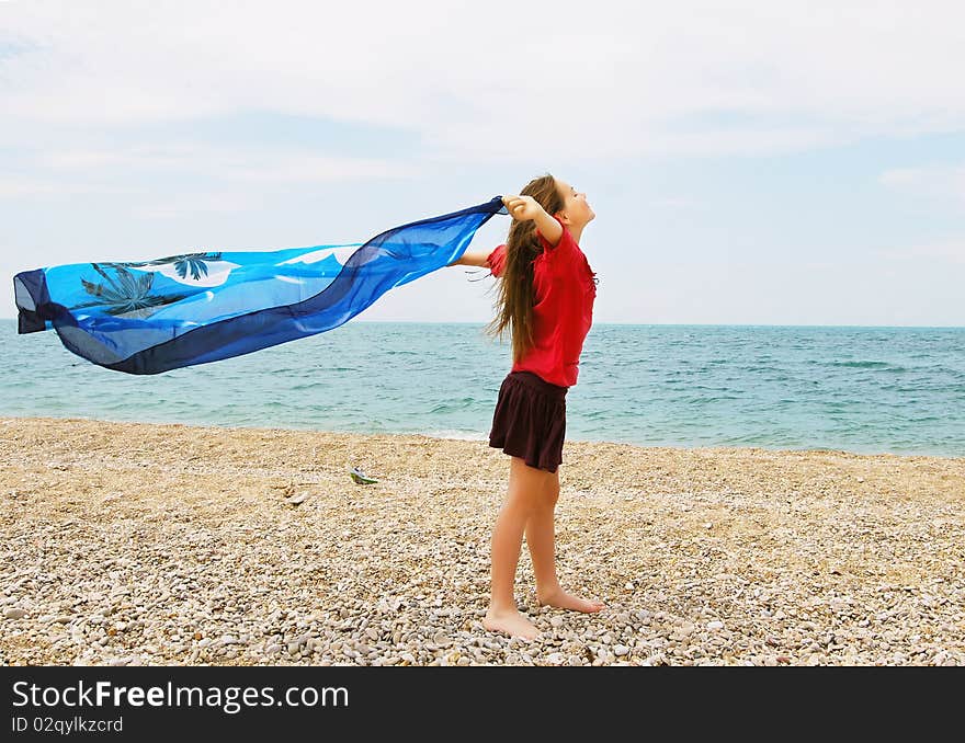 Happy girl by the sea in summer