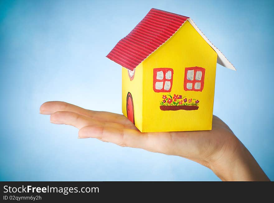 Woman holding a house in her hand. Woman holding a house in her hand