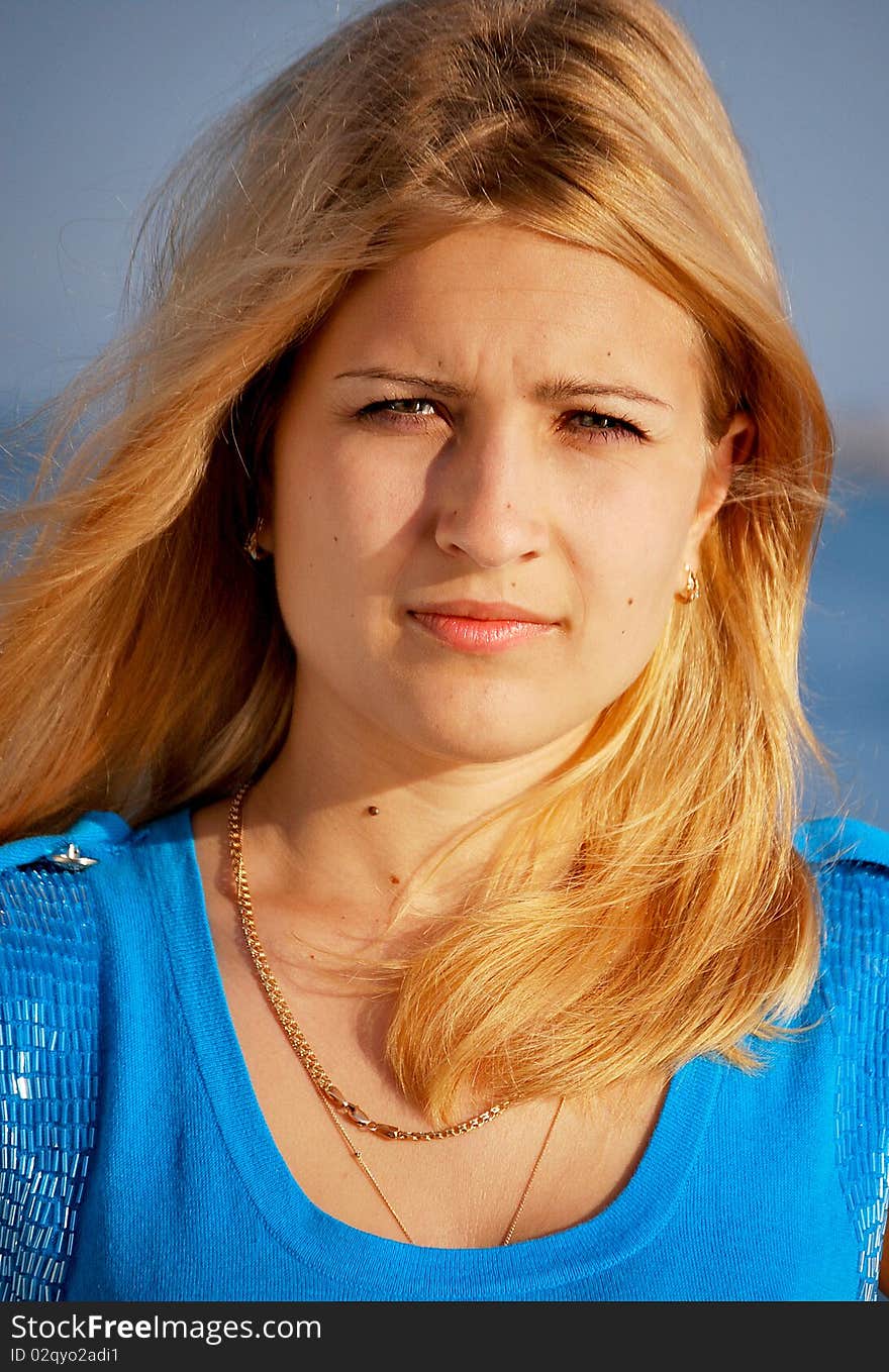 Young beautiful girl portrait by the ocean. Young beautiful girl portrait by the ocean