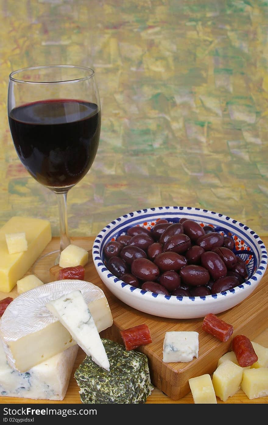 Cheese antipasto varieties with olives and wine. Cheese antipasto varieties with olives and wine