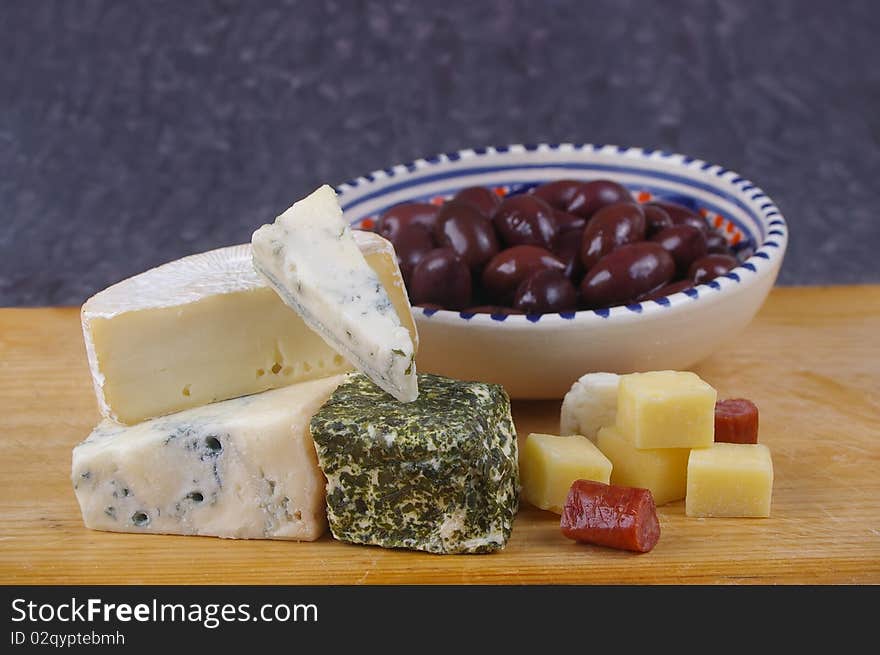 Cheese antipasto varieties on board with kalamata olives. Cheese antipasto varieties on board with kalamata olives