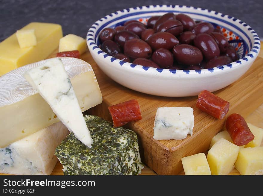 Cheese antipasto varieties on board with kalamata olives. Cheese antipasto varieties on board with kalamata olives