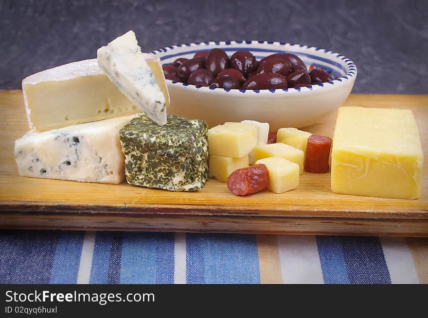 Cheese antipasto varieties on board with kalamata olives. Cheese antipasto varieties on board with kalamata olives