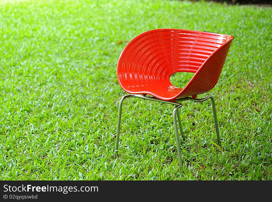 Red chair in green garden