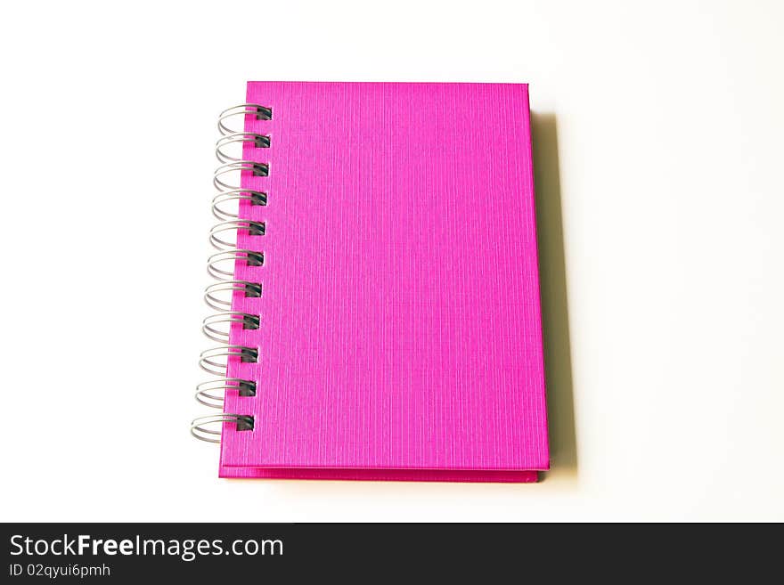 The blank pink notebook isolated on the white background