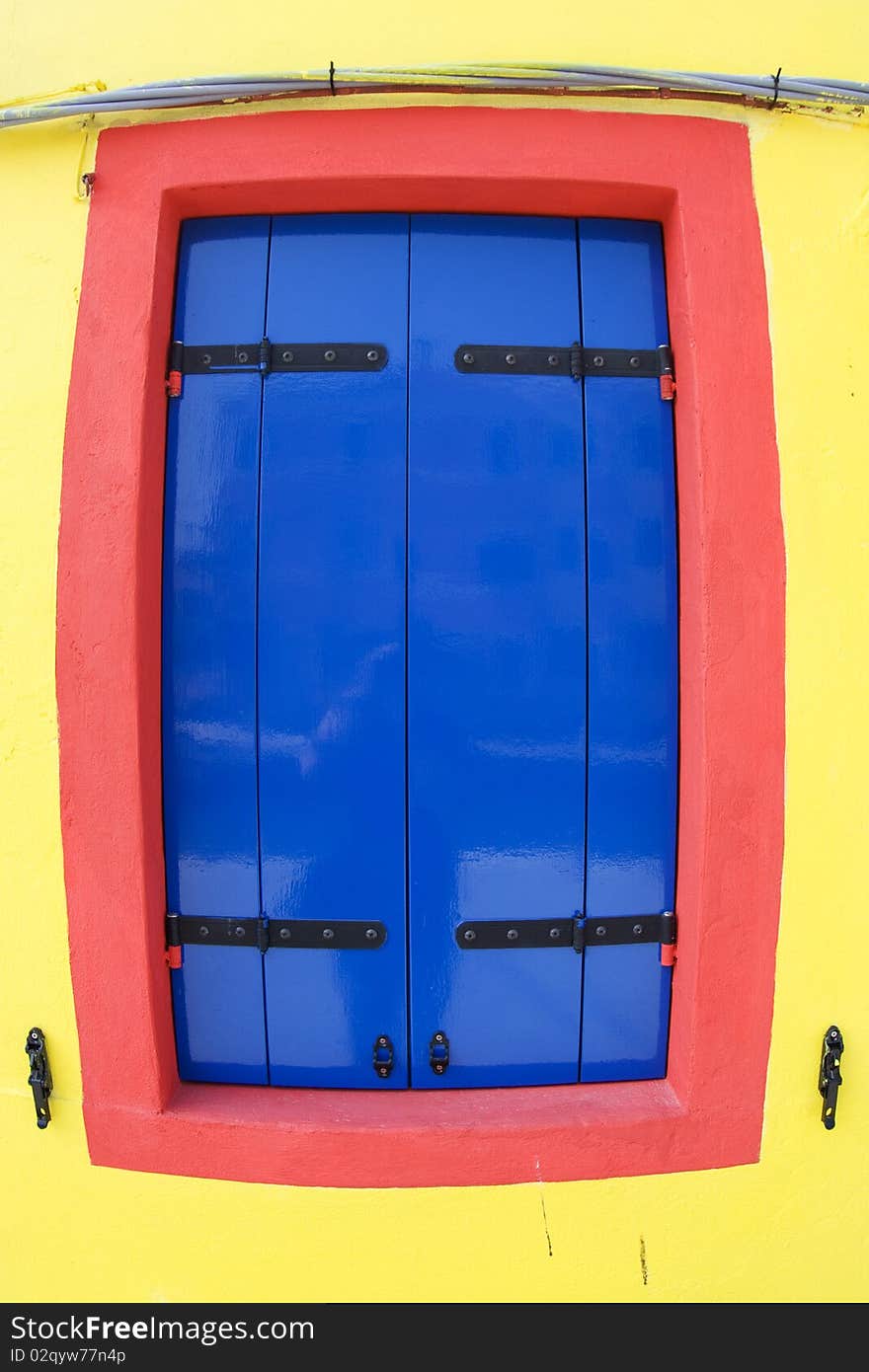 Colorful facade of an old fisher house in the village of Burano near Venice. Colorful facade of an old fisher house in the village of Burano near Venice