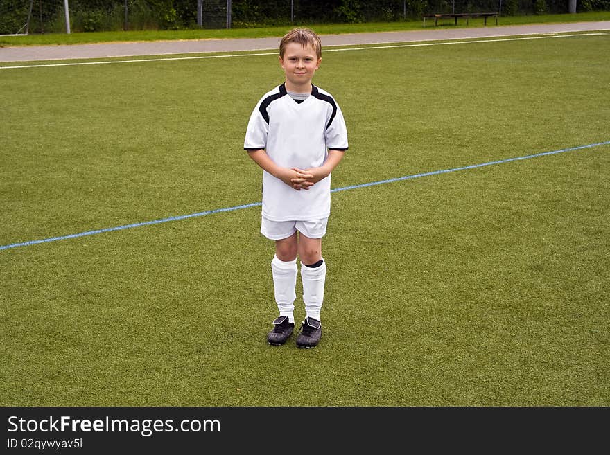 Proud player for a young youth soccer team looks proud in his tricot. Proud player for a young youth soccer team looks proud in his tricot