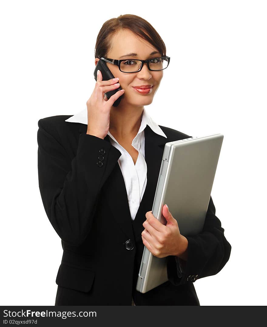 Young successful career woman holds her laptop and talks on her mobile phone. Young successful career woman holds her laptop and talks on her mobile phone