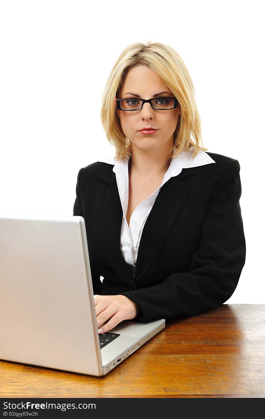 Young successful woman working at desk with laptop isolated on white. Young successful woman working at desk with laptop isolated on white