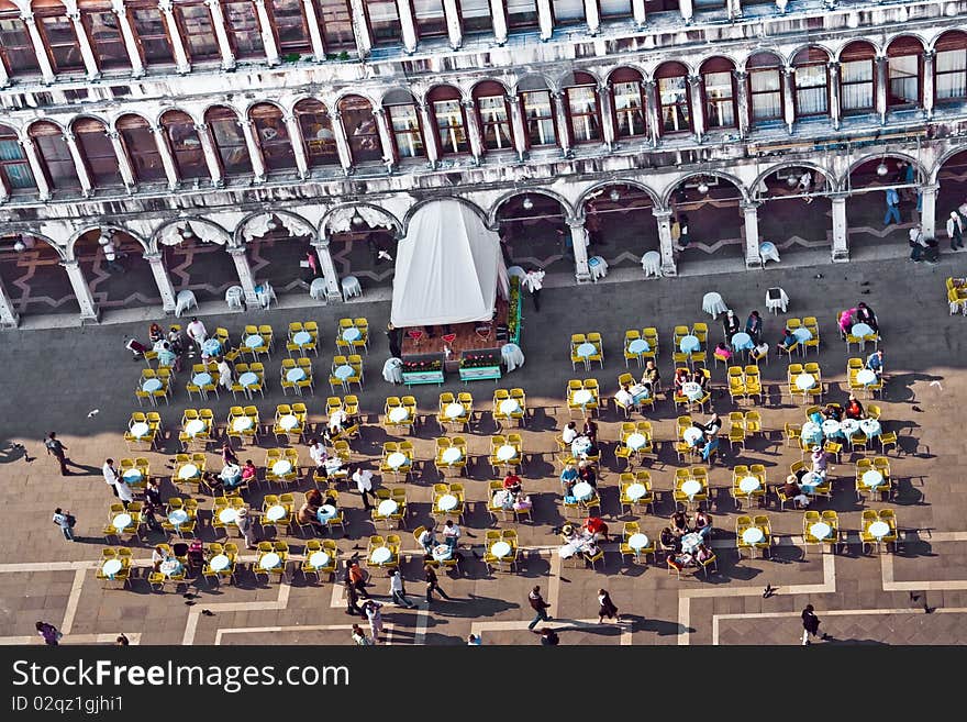 Venice, famous marcus place with cafe and tables with people seen from the marcus tower