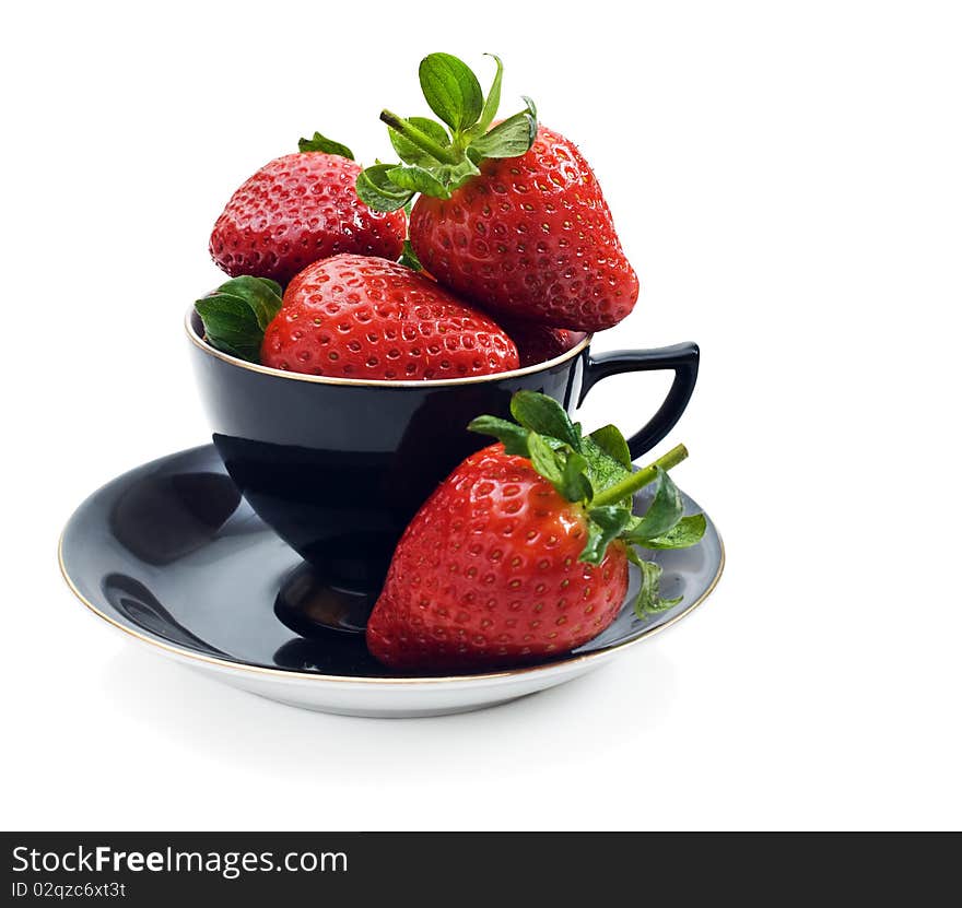 Fresh strawberries in an antique black tea cup. Fresh strawberries in an antique black tea cup