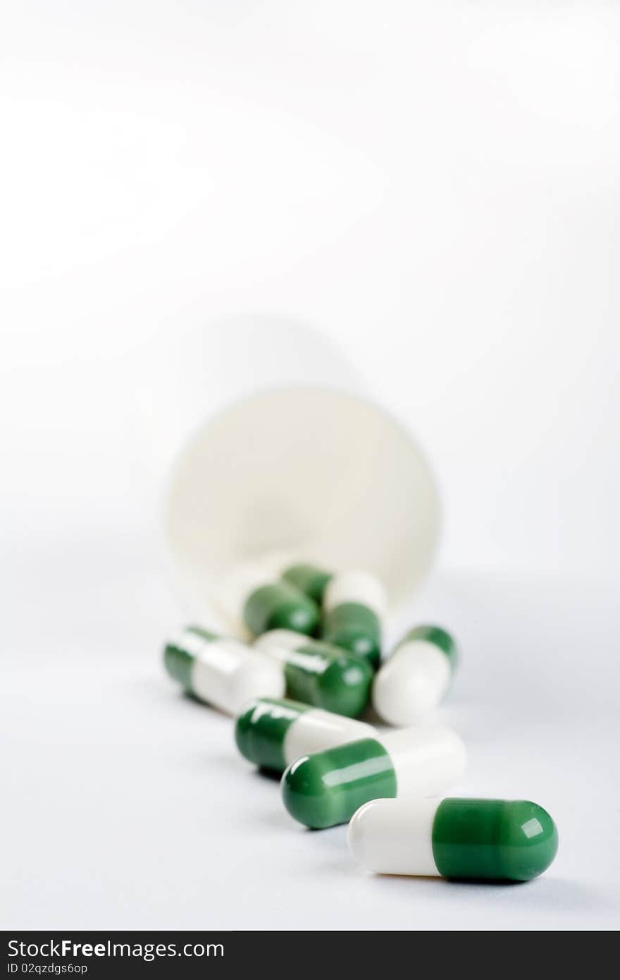 Pack of green capsules isolated on white