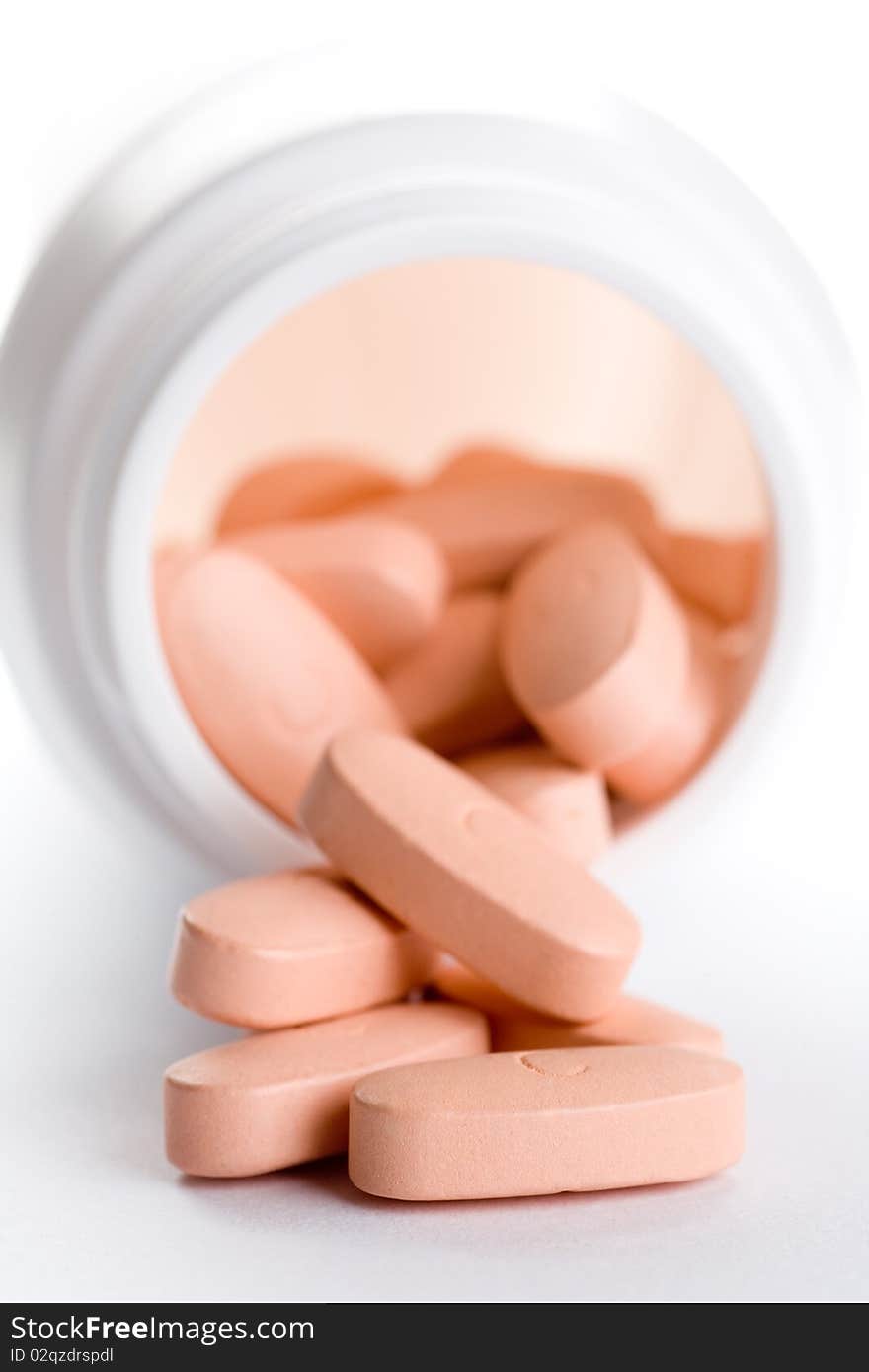 Closeup of a pack of pink pills, isolated