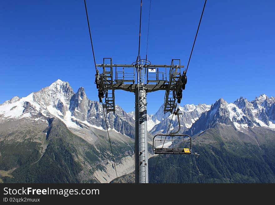 Chair lift and mountains and sky blue