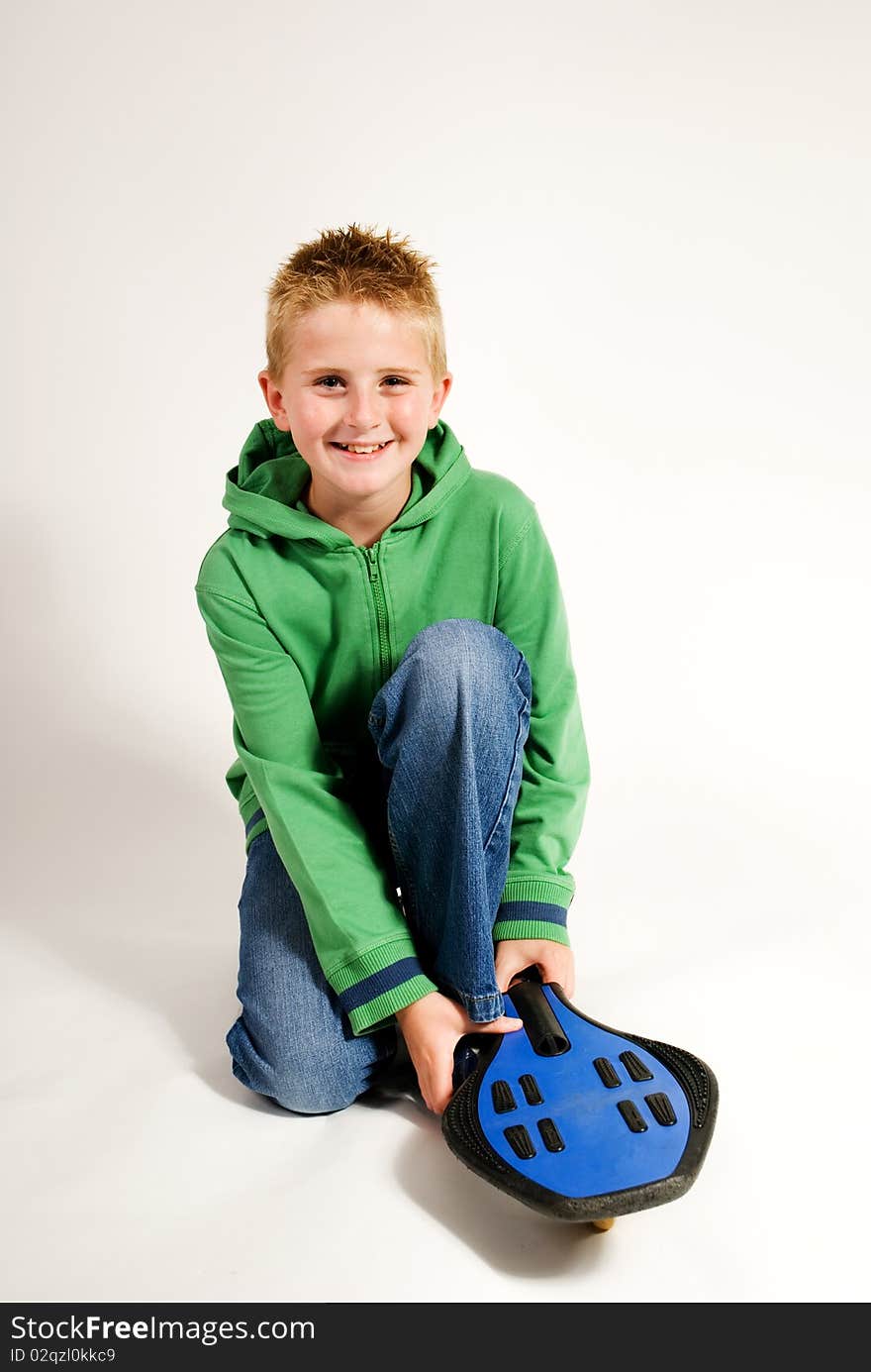 Young Teenager Kneeling With Waveboard