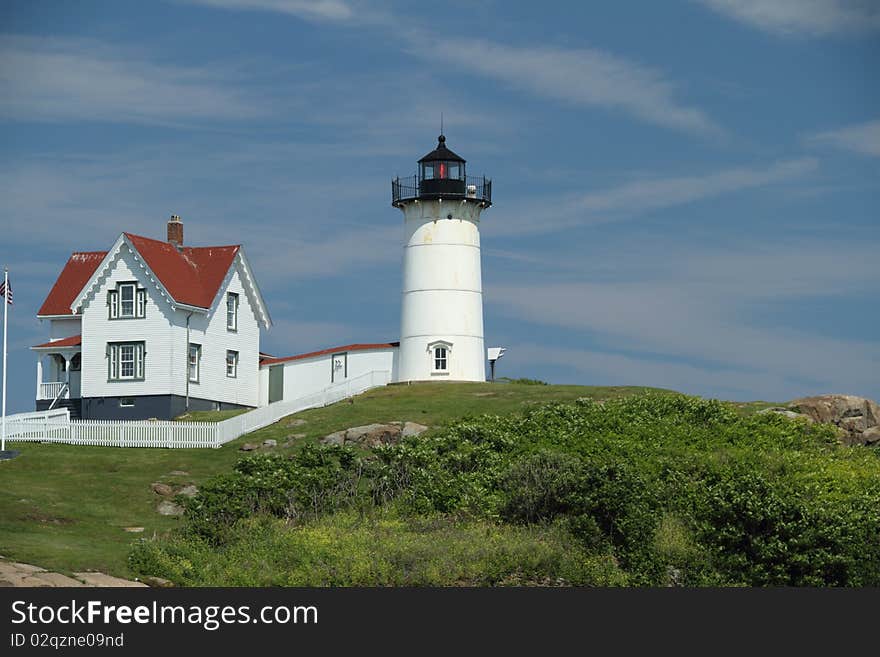 The cape Neddick light house with a partly cloudy sky. The cape Neddick light house with a partly cloudy sky.