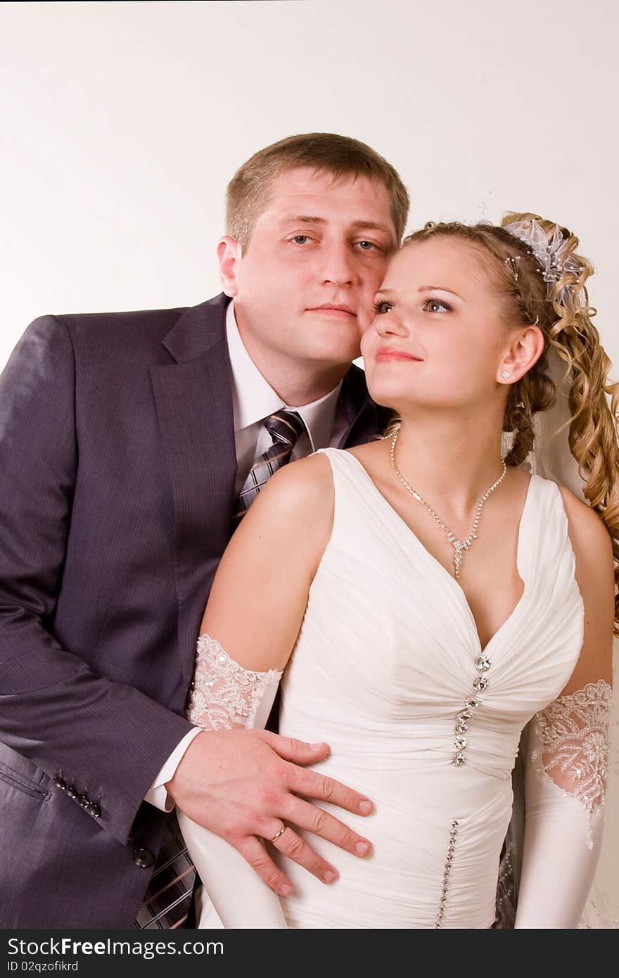 Photography of happy newly-wed is in a studio